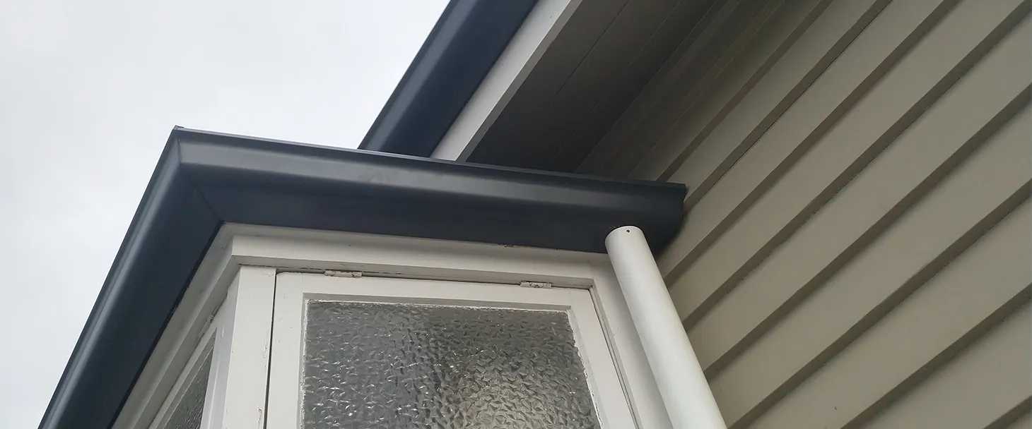 Continuous Spouting installer fitting new colour steel spouting on a Hawke's Bay home