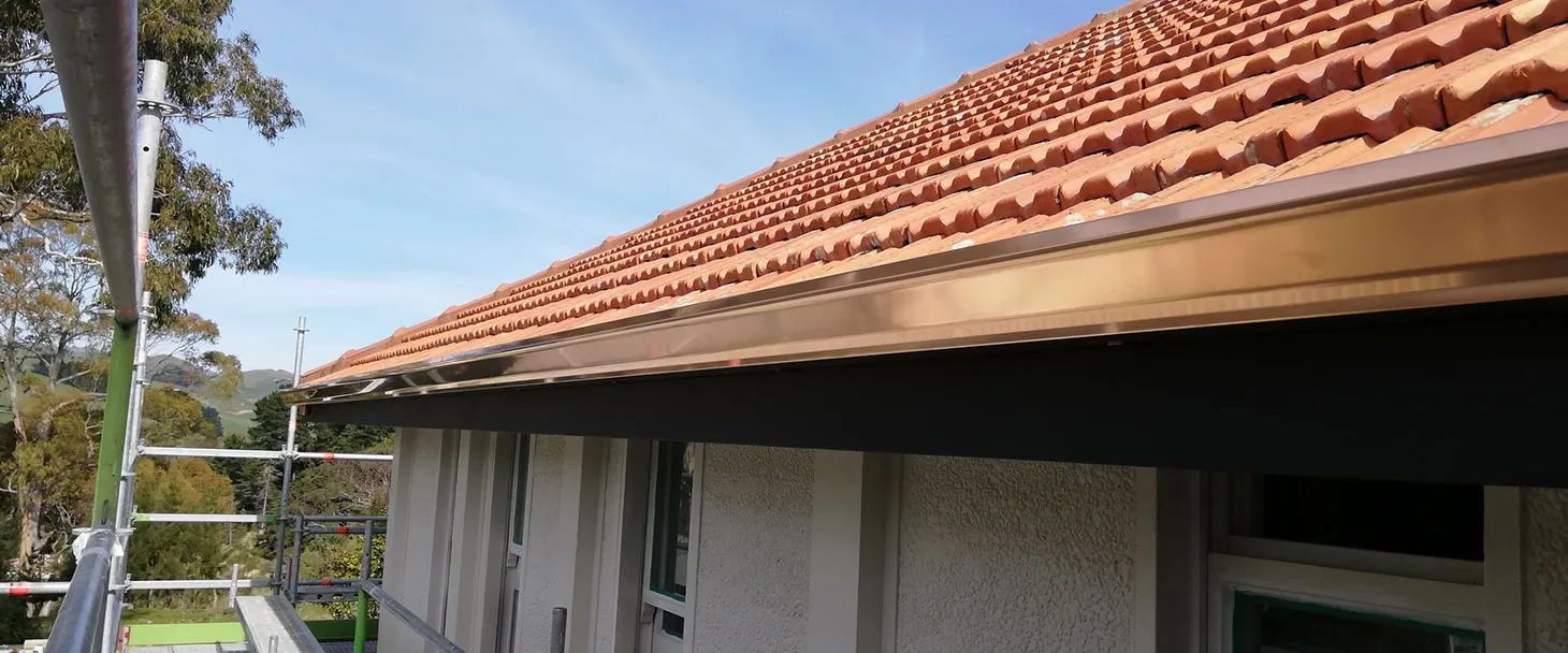 New colour steel spouting and fascia fitted along a tiled roofline on a Hawke's Bay home