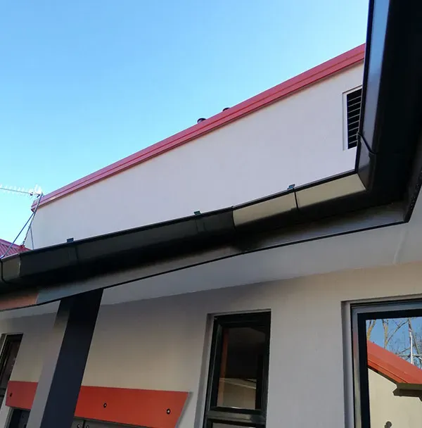 Deep Quad continuous spouting on a bevelled rake roofline, detail view